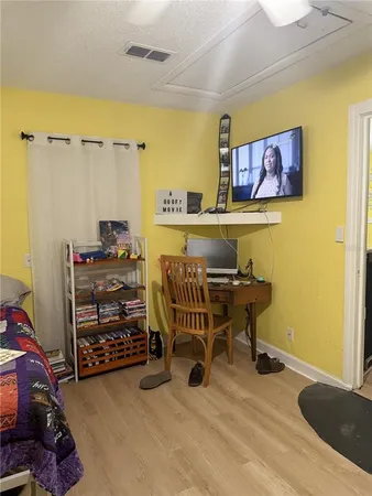 a view of a workspace with furniture and a bathroom