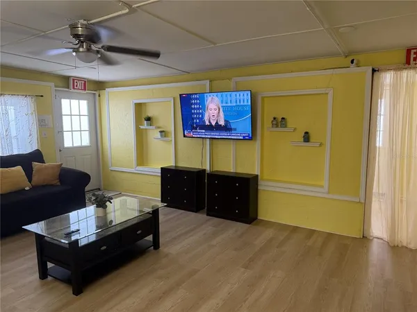 a living room with furniture and a flat screen tv