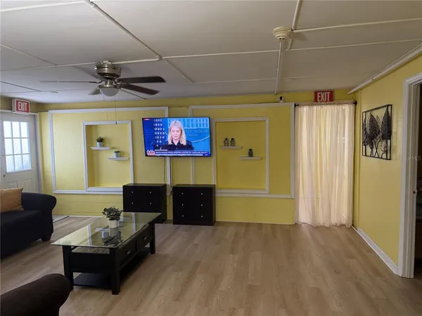 a living room with furniture and a flat screen tv