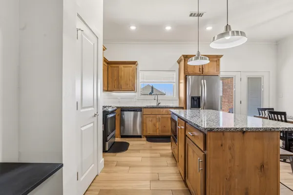 a spacious bathroom with a granite countertop sink a mirror and shower