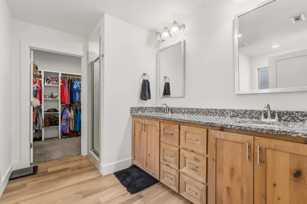 a bathroom with a granite countertop sink and a mirror