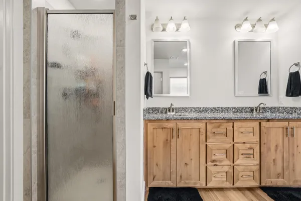 a bathroom with a granite countertop sink and a mirror