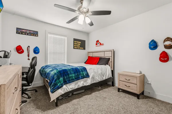 a bedroom with a bed and a window