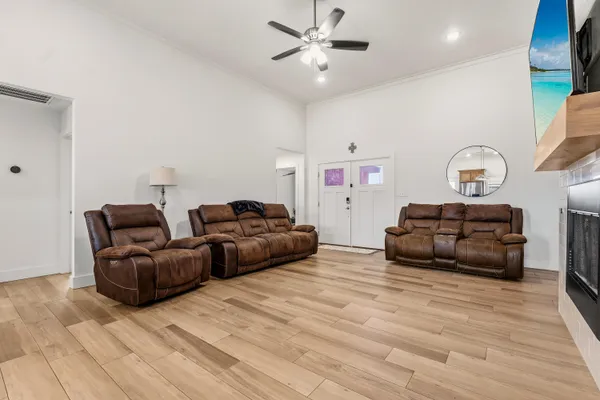 a living room with furniture and a wooden floor