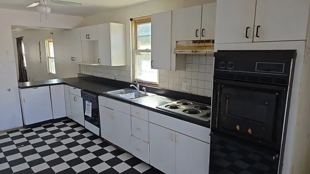 a kitchen with a sink stove and cabinets