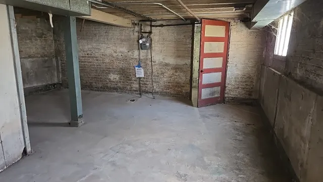 a view of empty room with wooden door