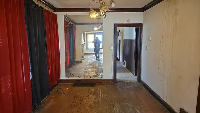 a view of a hallway with wooden floor and staircase