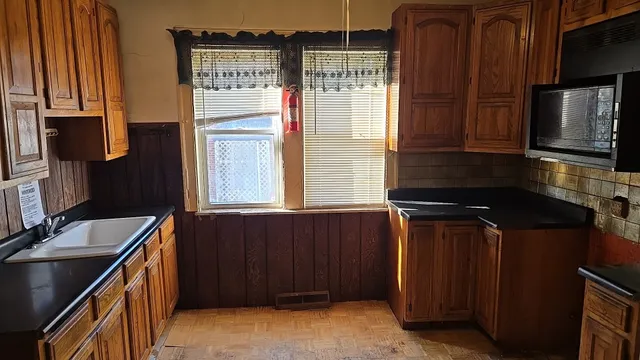 a kitchen with stainless steel appliances granite countertop a refrigerator and a stove