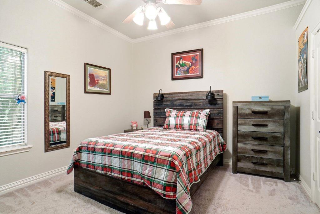 620 Highview Lane Hurst, TX 76054 - Photo 32 of 40 a bedroom with a bed and a dresser