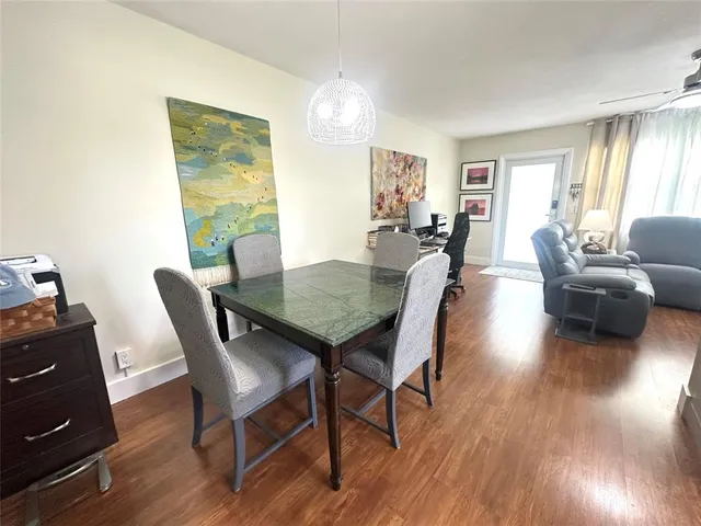 a dining room with furniture and wooden floor