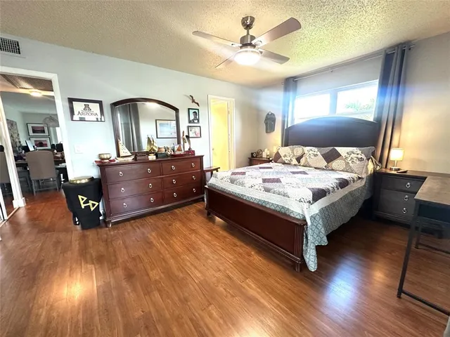 a bedroom with furniture and a wooden floor