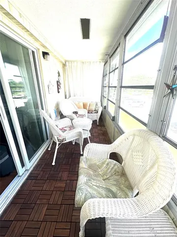 a living room with a bed and a window