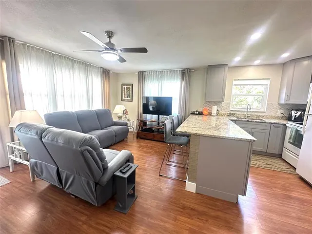 a living room with furniture window and wooden floor