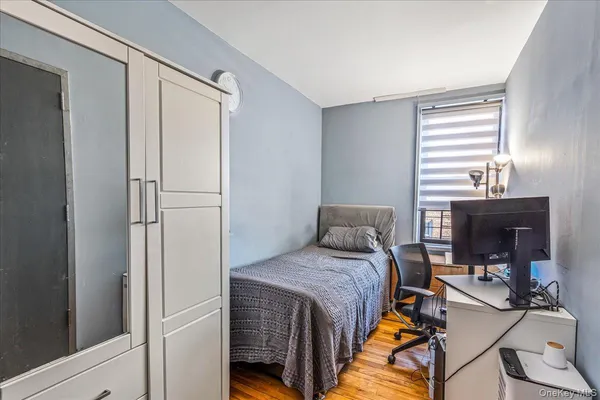 a bedroom with a bed and a mirror