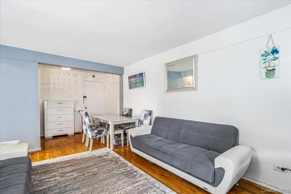 a living room with furniture a rug and a table