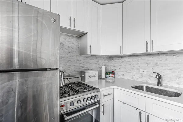 a kitchen with a white cabinets and white stove