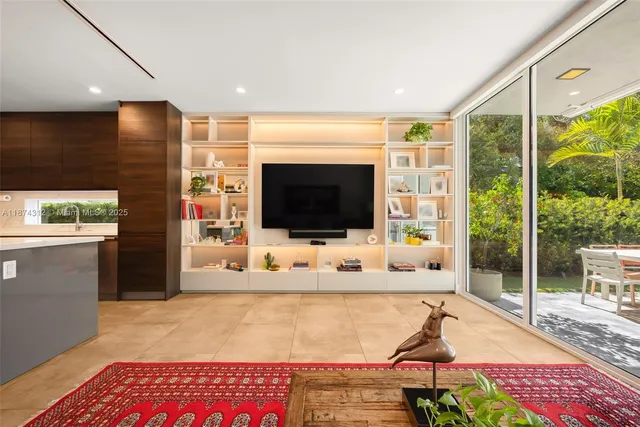 a living room with a flat screen tv and a floor to ceiling window