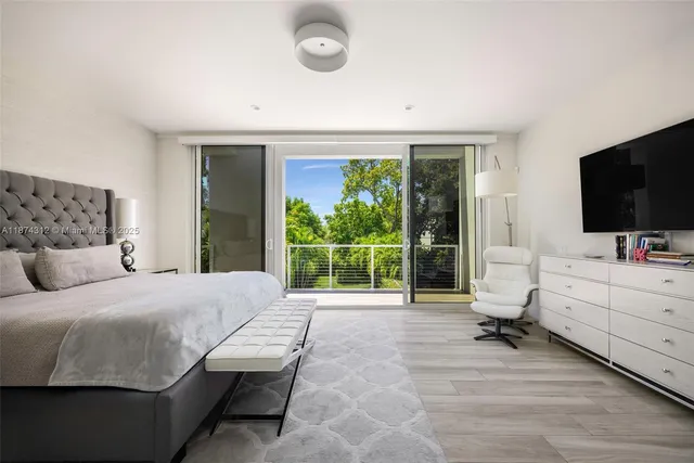 a bedroom with a bed and large window