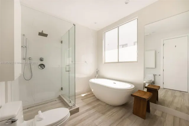 a spacious bathroom with a toilet a sink and bathtub