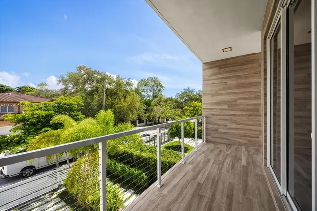 a view of a balcony with wooden floor