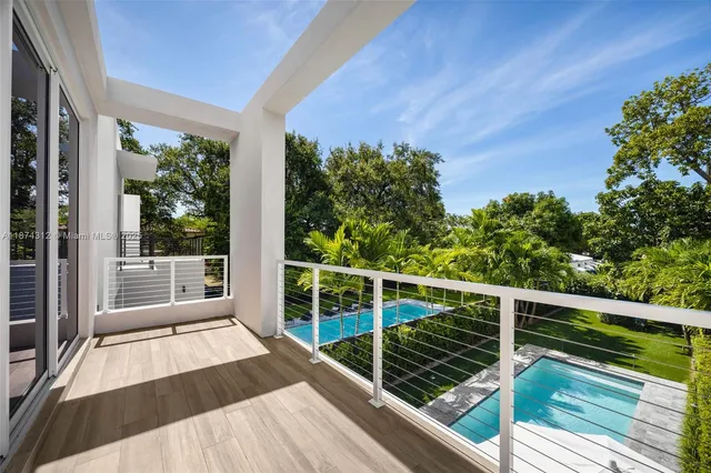 a view of balcony with wooden floor and fence