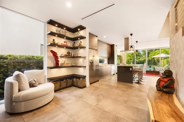 a view of living room filled with furniture and floor to ceiling window