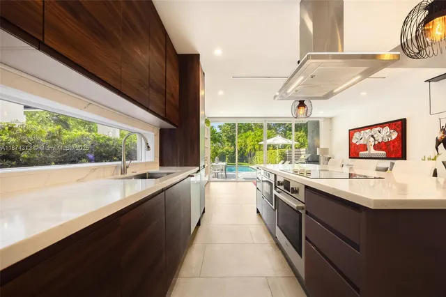 a large kitchen with kitchen island a large window in it