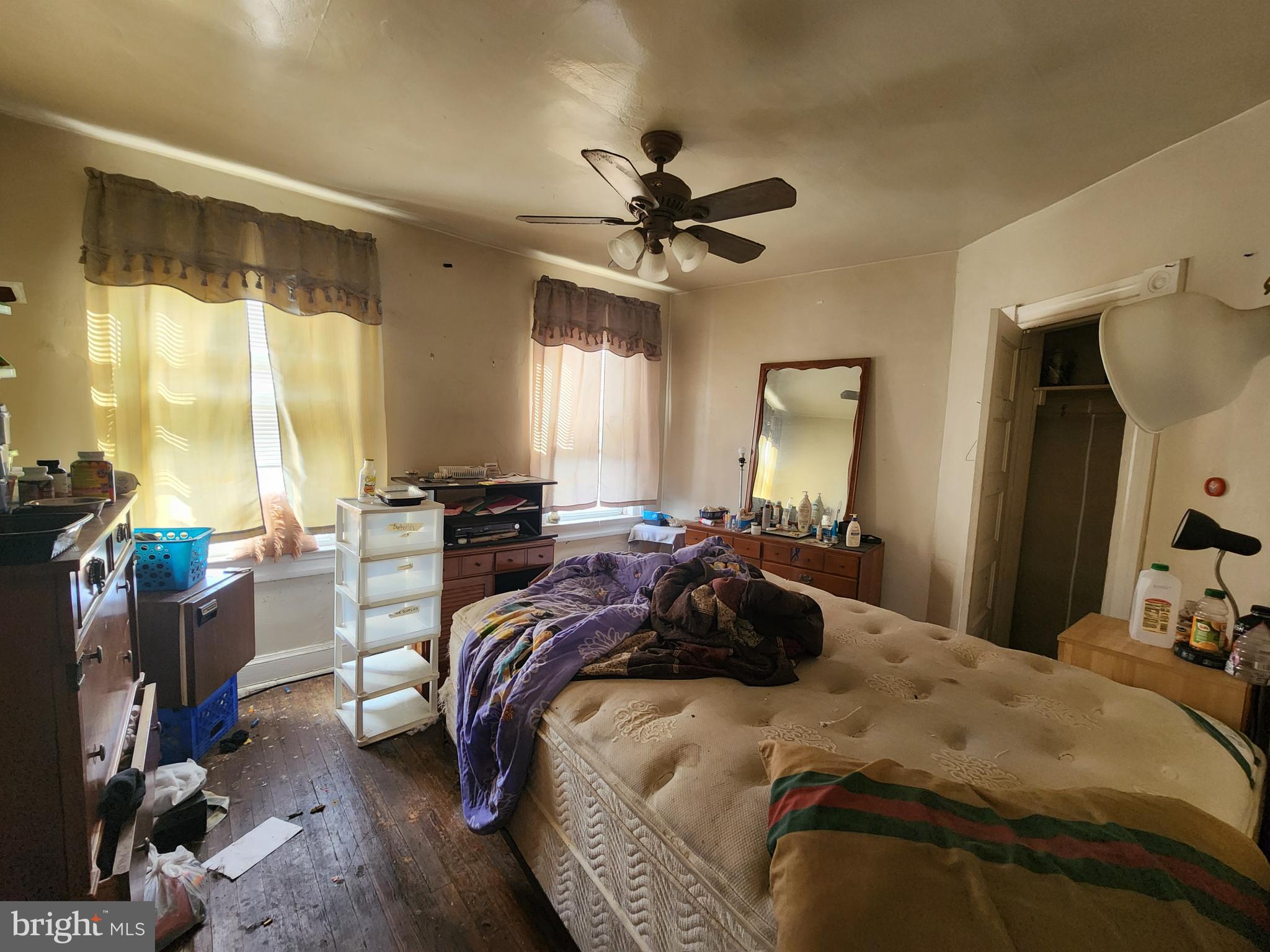 2019 Cecil Avenue Baltimore, MD 21218 - Photo 13 of 17 a bedroom with a bed a chandelier and a large window