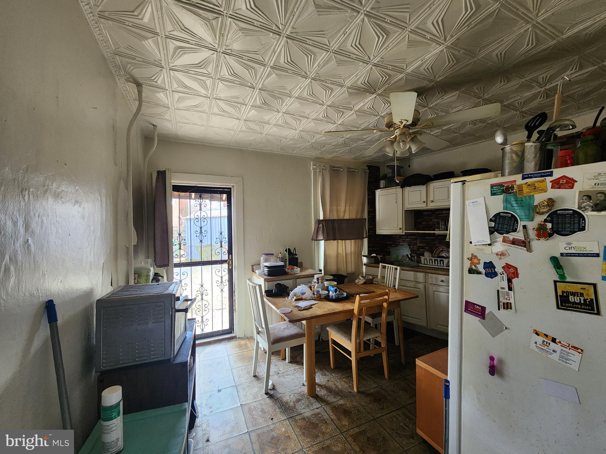 2019 Cecil Avenue Baltimore, MD 21218 - Photo 6 of 17 a dining room with furniture and a chandelier