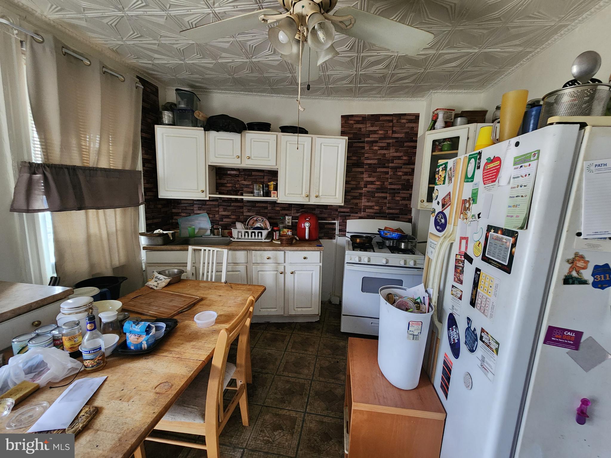 2019 Cecil Avenue Baltimore, MD 21218 - Photo 7 of 17 a kitchen with stainless steel appliances a stove a sink a refrigerator and cabinets