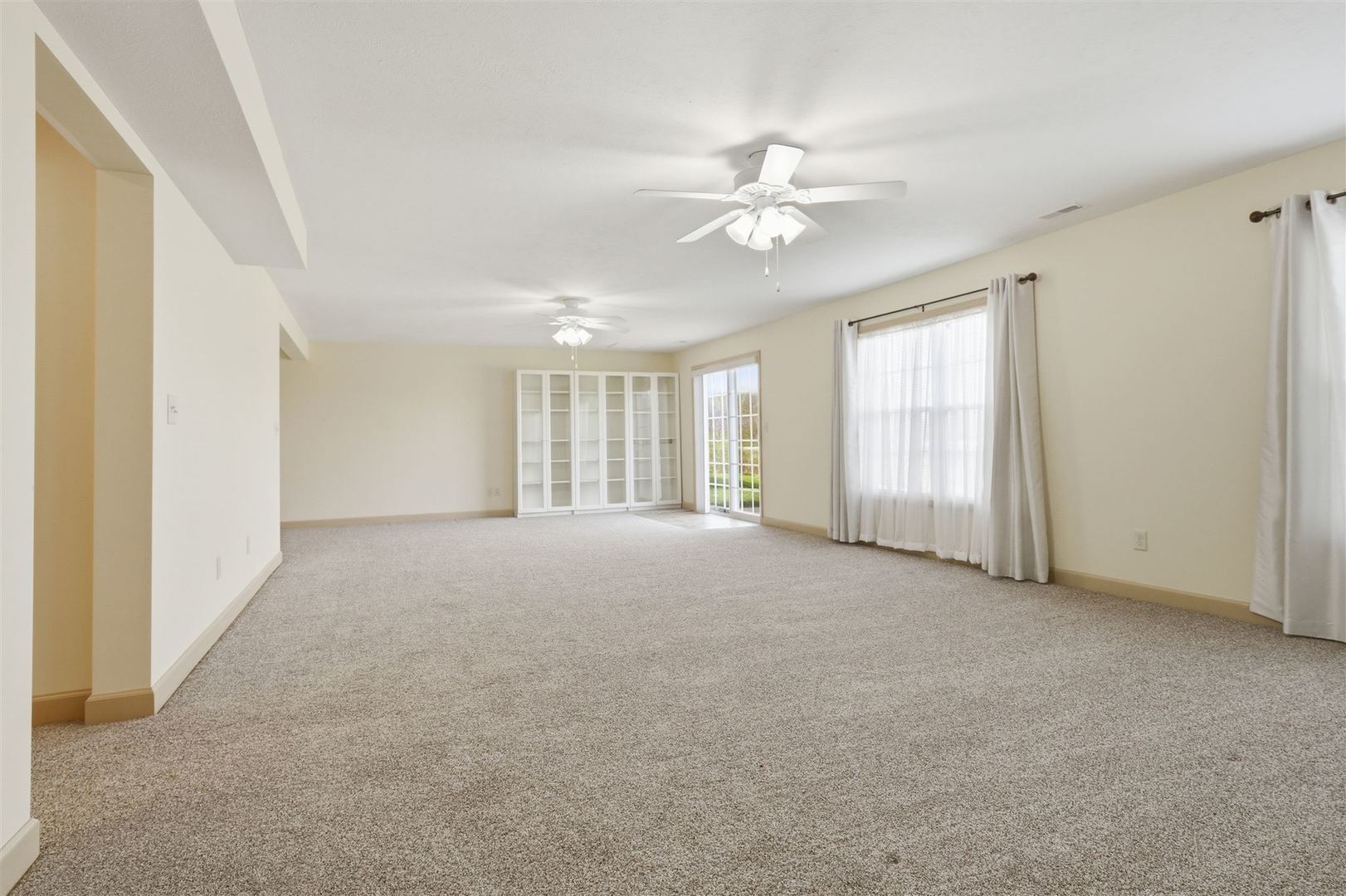 171 Eugene Drive Normal, IL 61761 - Photo 20 of 29 a view of a livingroom with a ceiling fan and window
