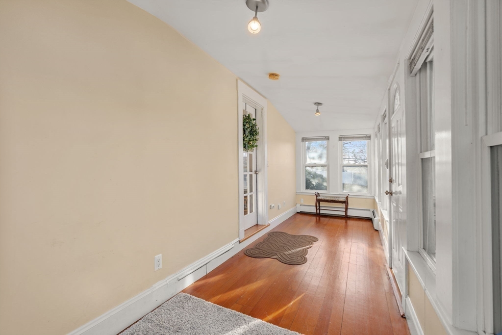 194 College Farm Road Waltham, MA 02451 - Photo 3 of 28 a view of an empty room with a fireplace and a window