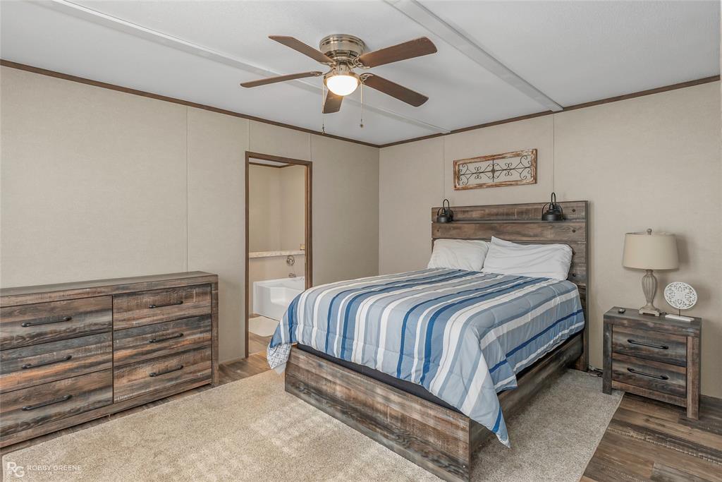 1048 Merritt Mountain Road Many, LA 71449 - Photo 11 of 27 a bedroom with a bed and a chandelier