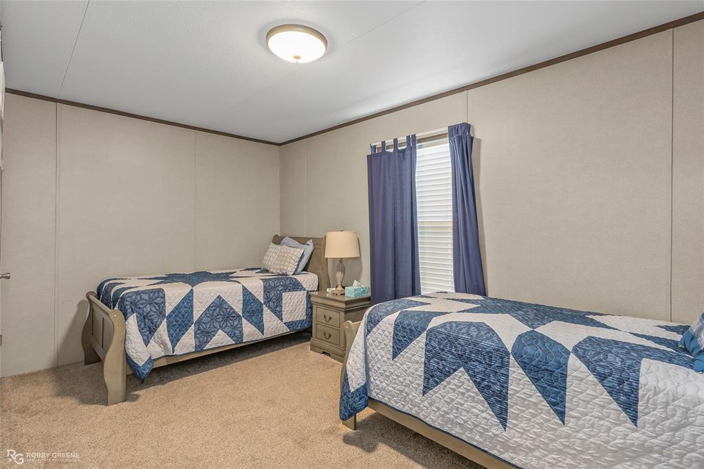 1048 Merritt Mountain Road Many, LA 71449 - Photo 18 of 27 a bed sitting in a bedroom next to a window