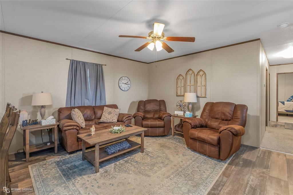1048 Merritt Mountain Road Many, LA 71449 - Photo 5 of 27 a living room with furniture and a chandelier