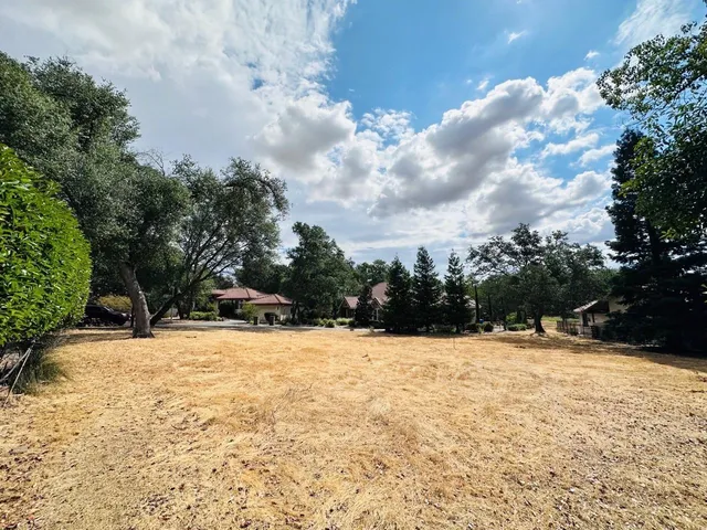 a view of side of snow with trees in the background