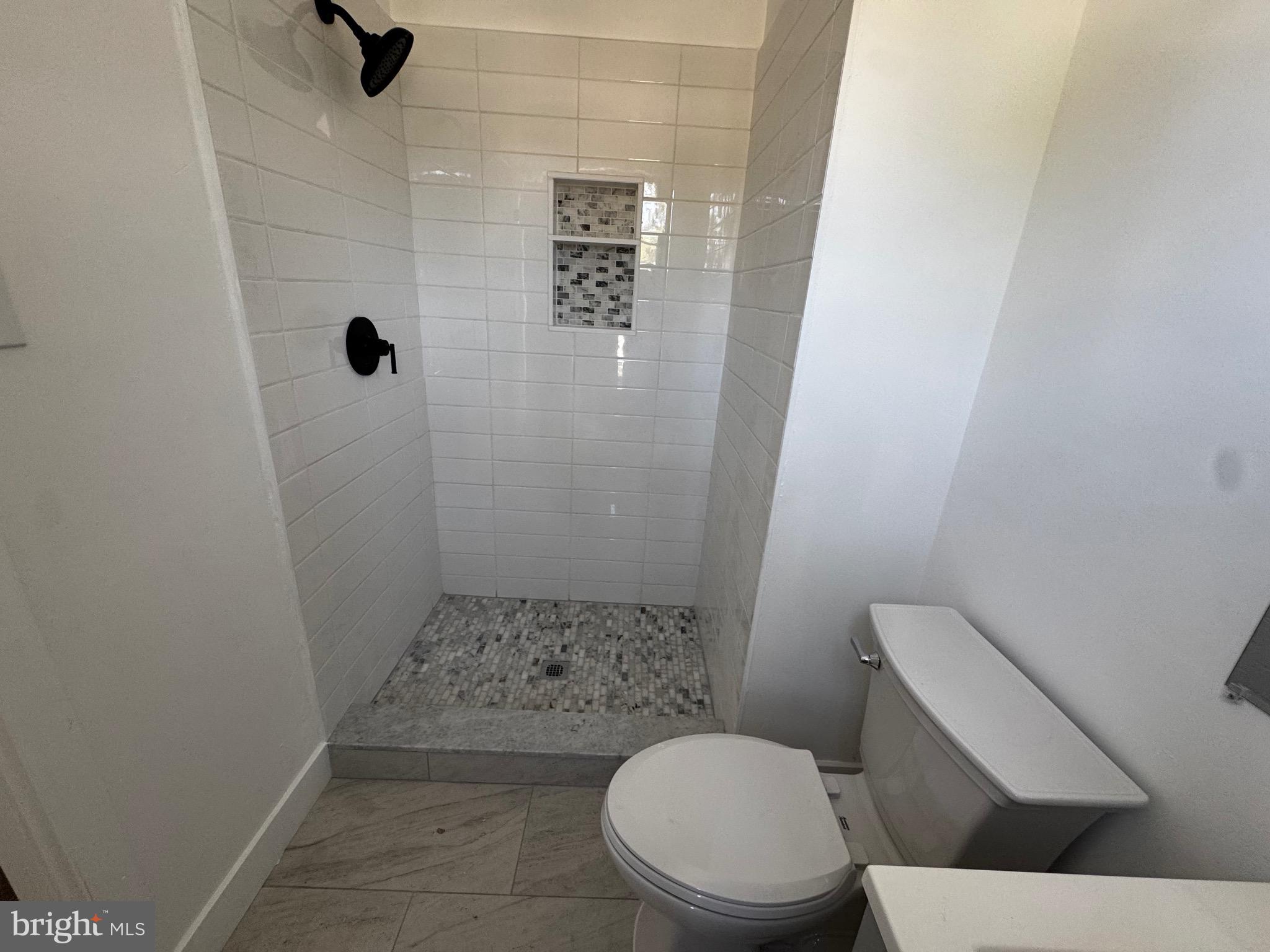 633 Foxton Court Mantua, NJ 08051 - Photo 3 of 14 a white toilet sitting next to a shower