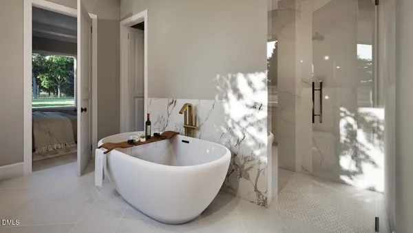 a white bath tub sitting in a bathroom and mirror