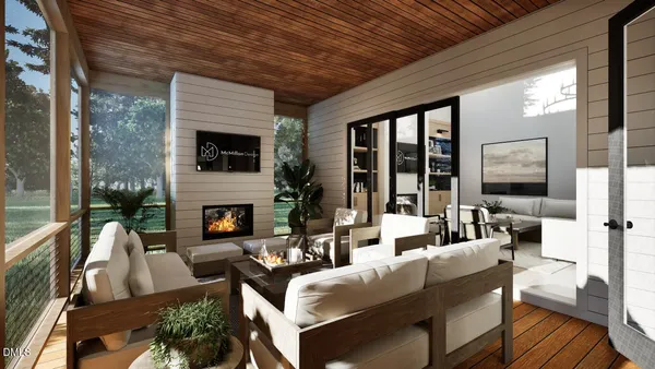 a living room with fireplace furniture and a large window