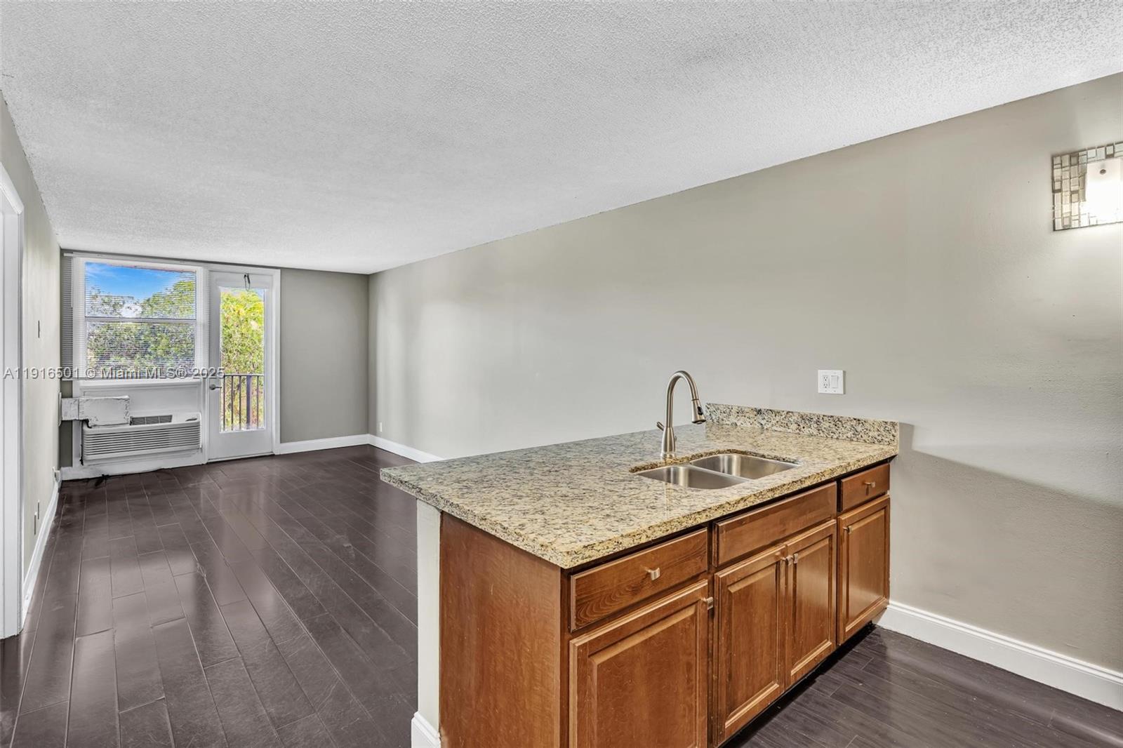 2701 Riverside Drive, Unit 303B Coral Springs, FL 33065 - Photo 1 of 19 a kitchen that has a sink and a wooden floor