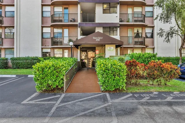 front view of a brick house with a yard