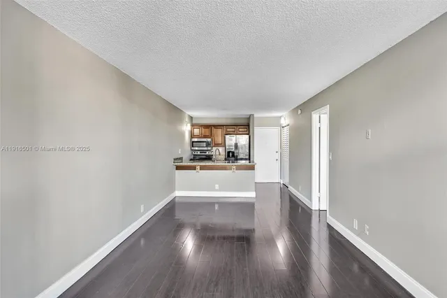 a view of a kitchen with a sink and a window