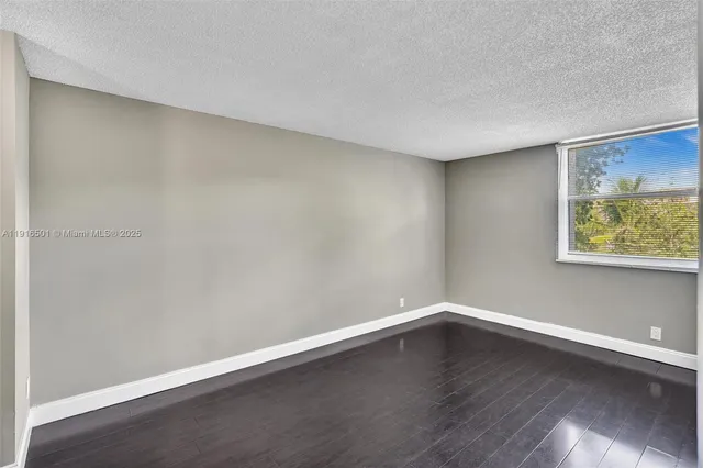 a view of a room with wooden floor and window