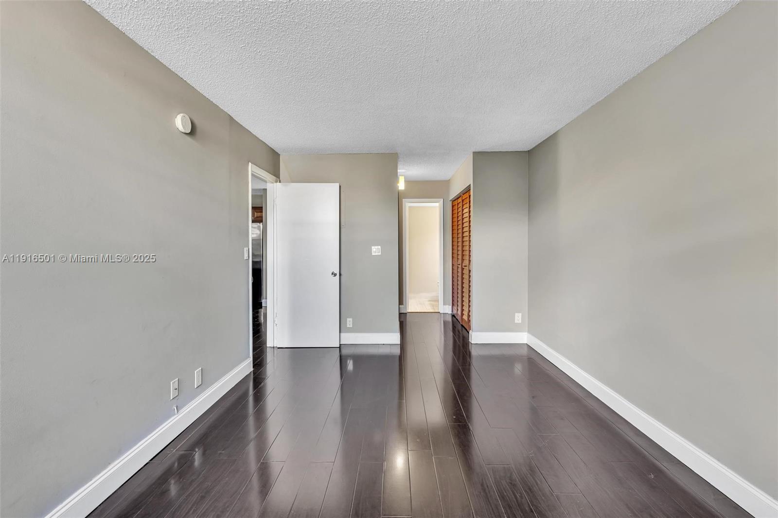 2701 Riverside Drive, Unit 303B Coral Springs, FL 33065 - Photo 7 of 19 a view of an empty room with wooden floor