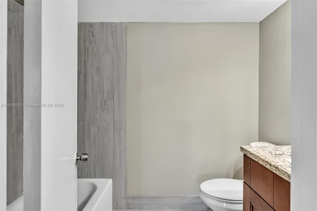 a white toilet and a shower curtain