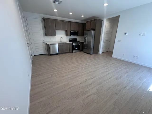 an empty room with a kitchen and a sink