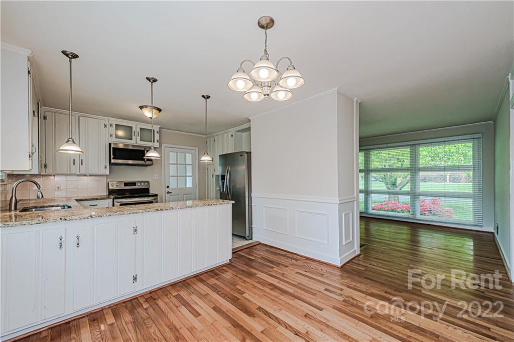 4301 Applegate Road Charlotte, NC 28209 - Photo 11 of 21 a kitchen with a sink stove and refrigerator