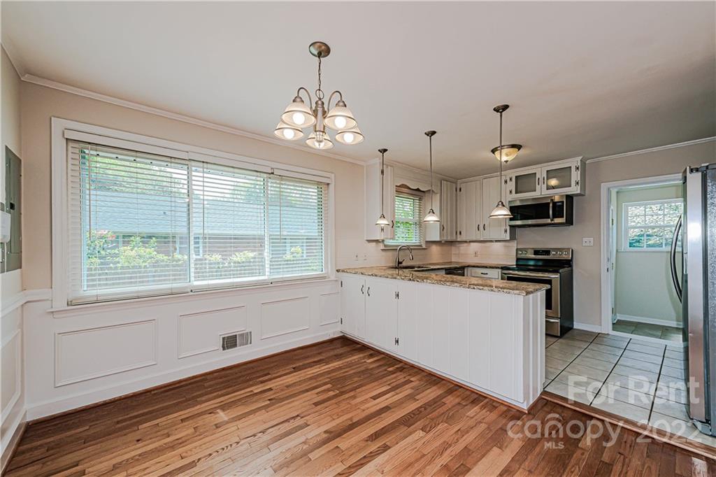 4301 Applegate Road Charlotte, NC 28209 - Photo 6 of 21 a kitchen with stainless steel appliances granite countertop a stove and a white cabinets