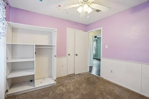 a view of an empty room with a cabinet