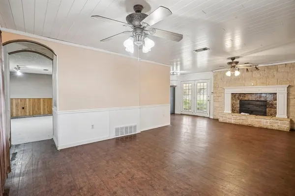 wooden floor in an empty room with a fireplace